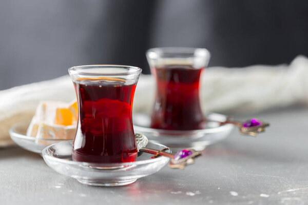 Red tea in turkish glasses on a wooden table