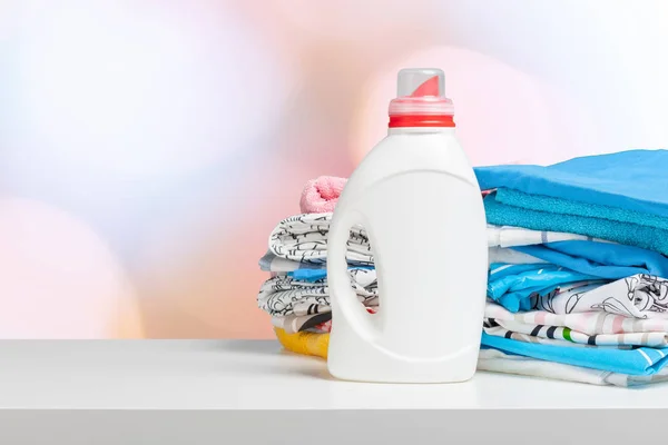 Clean laundry and liquid washing detergent front view