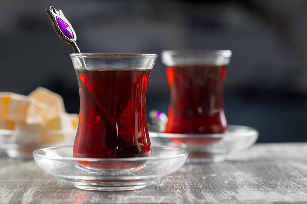 Red tea in turkish glasses on a wooden table