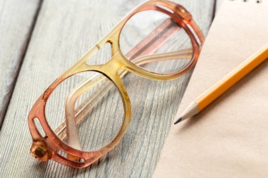 Not defteri ve gözlük masaya yakın çekim