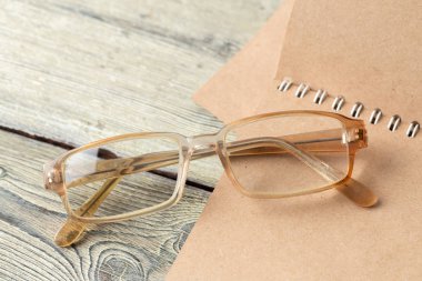 Not defteri ve gözlük masaya yakın çekim