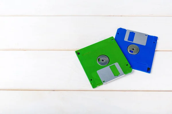 close up of floppy disks on wooden background