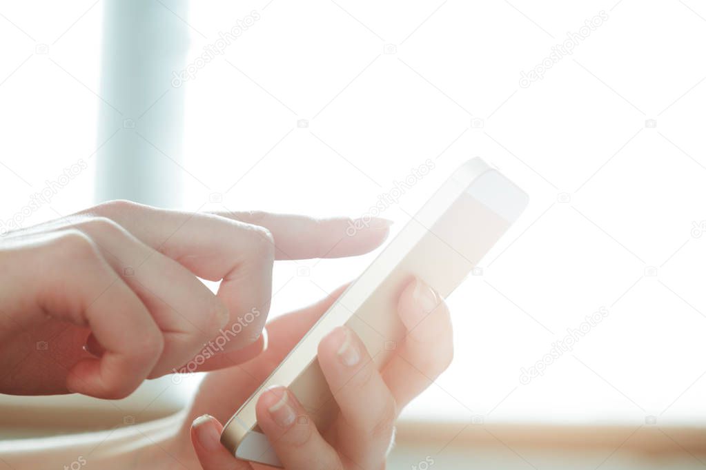 Woman typing message on smart phone