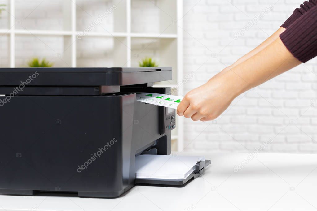 close up of person using modern printer in office