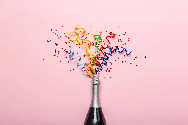 Champagne bottle with colorful party streamers