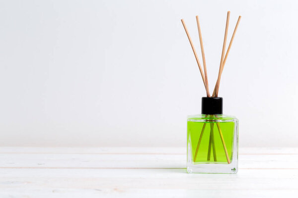 air freshener sticks  on wooden background 