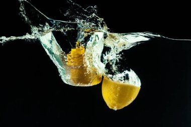 Siyah arka planda taze sarı limonlar.