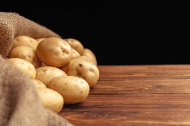 Olgun patates ahşap tahta üzerinde yalan yığını