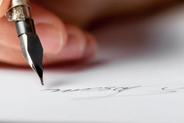 close up of person writing with Antique fountain pen