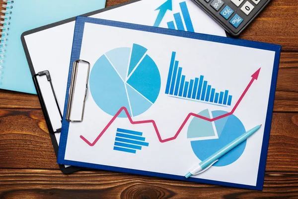 Top view of business paper chart or graph on wooden table