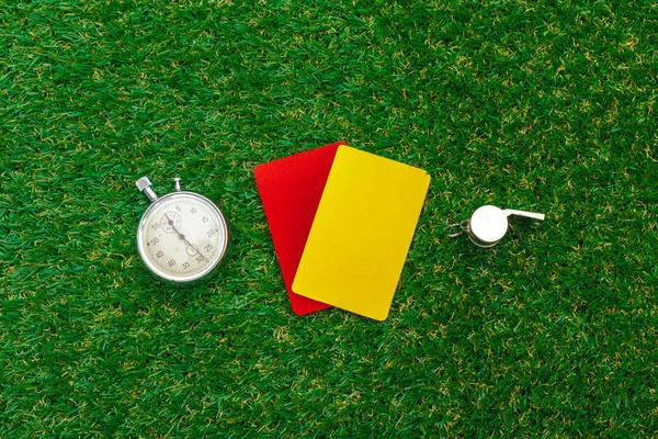 two penalty cards and a whistle for the referee