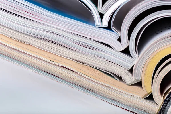 Close up of magazine stack on white background