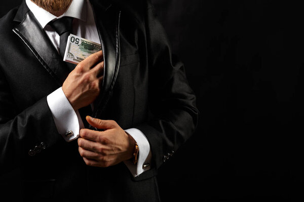 Man holding Money in hand at Black Background