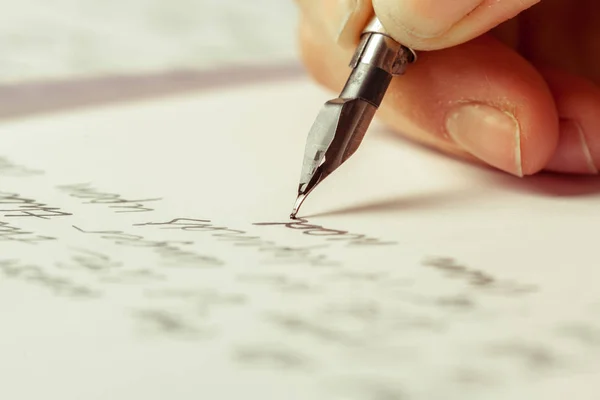 close up of person writing with Antique fountain pen