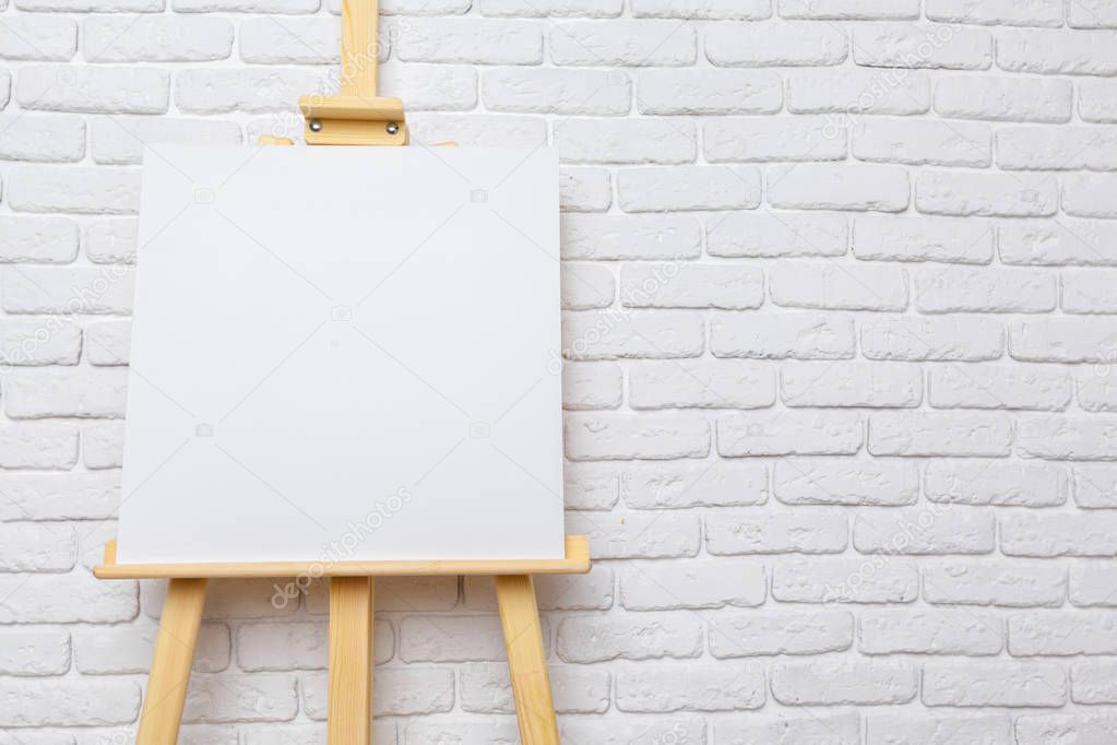 Modern wooden easel standing in room