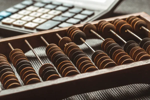 close up of vintage wooden abacus and calculator