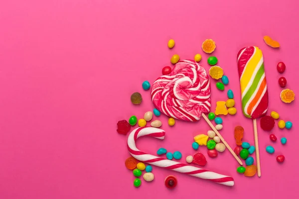 Kleurrijke Lollies Een Roze Achtergrond — Stockfoto