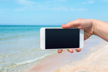 Güzel kadın eli beach adlı akıllı telefon kullanma