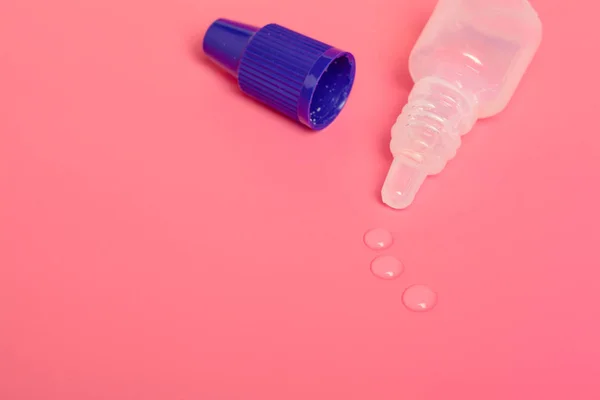 Eye drops isolated on pink background