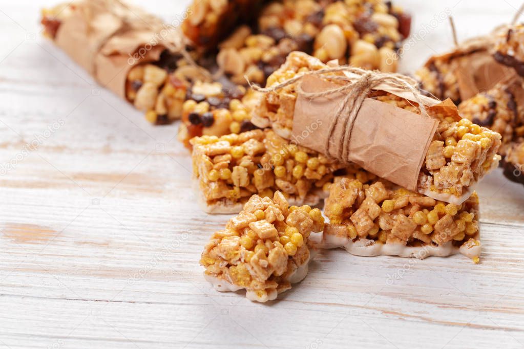 Granola bars on wooden background