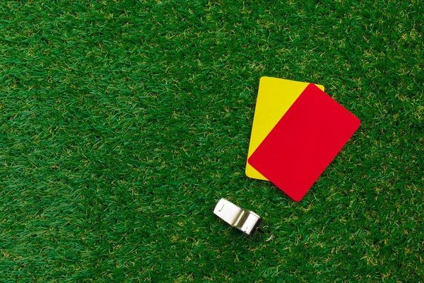 two penalty cards and a whistle for the referee