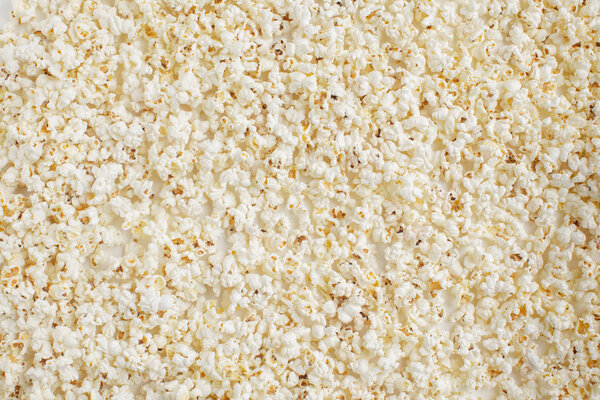 Pile of fresh crunchy popcorn, food background