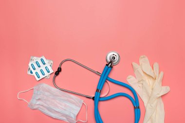 pastel pembe bir arka plan üzerinde tıbbi ekipman üstten görünüm.