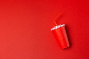 Red paper cup isolated on red. clipart