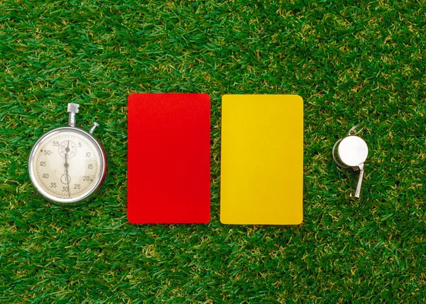 two penalty cards and a whistle for the referee