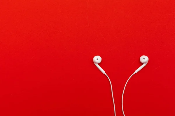 close up of Earphones on color background.