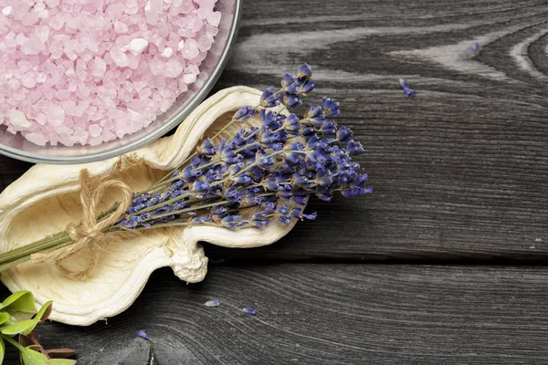 Aromatic composition of lavender, herbs and salt on a dark table top