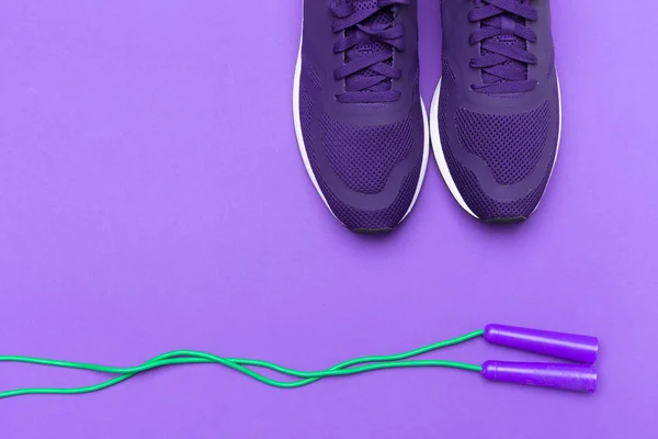 Purple sportive sneakers on purple background