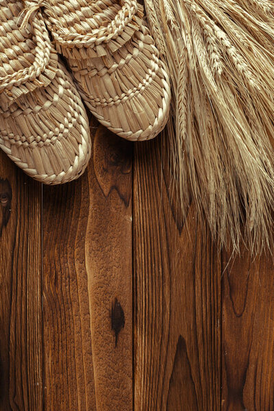 Old bast shoes on wooden background