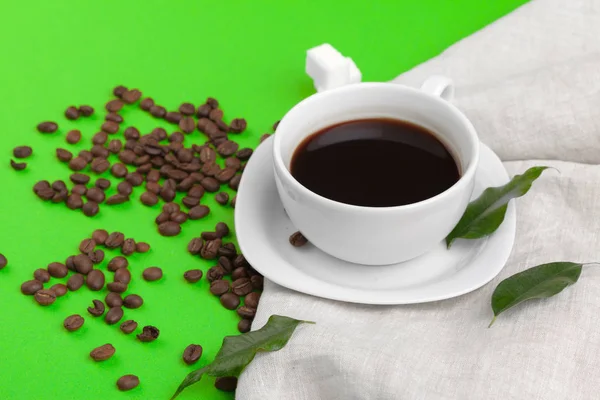 overhead view of Cup of coffee on green background.