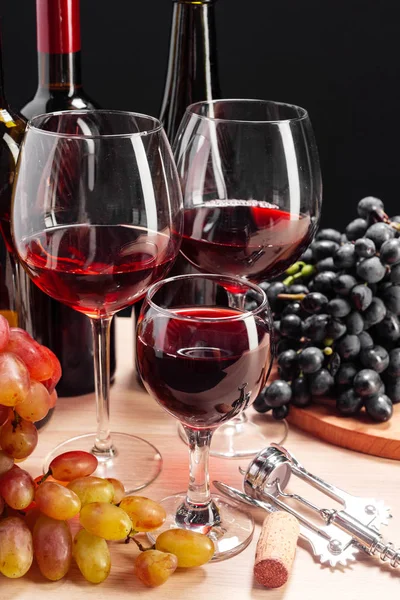 Wine and fresh grapes on dark background