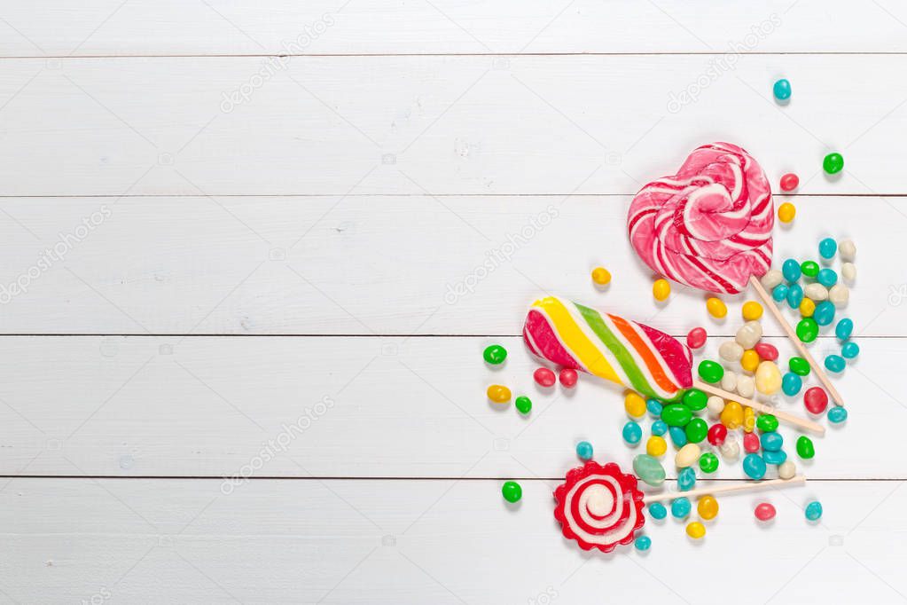 close up of Colorful candies on wooden background
