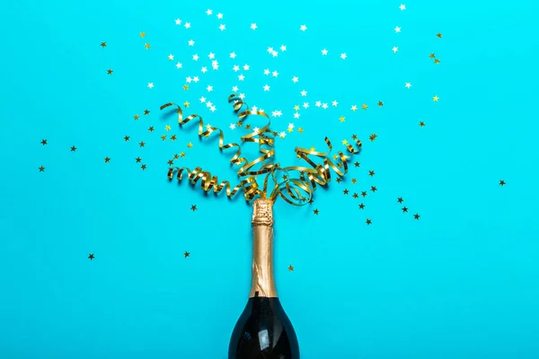 Champagne bottle with colorful party streamers