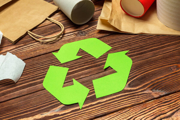 Eco concept with recycling symbol on table background top view