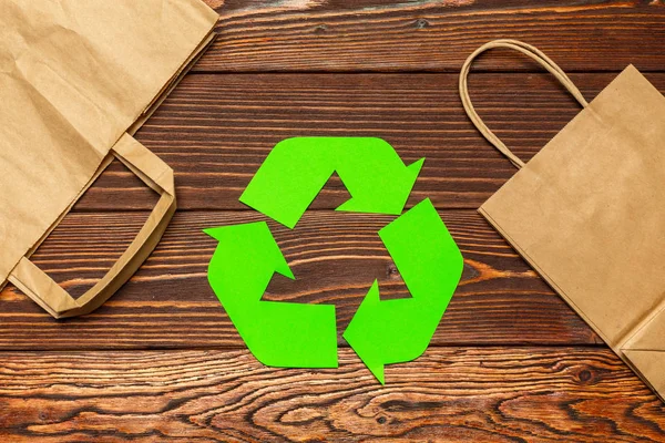 Eco concept with recycling symbol on table background, top view