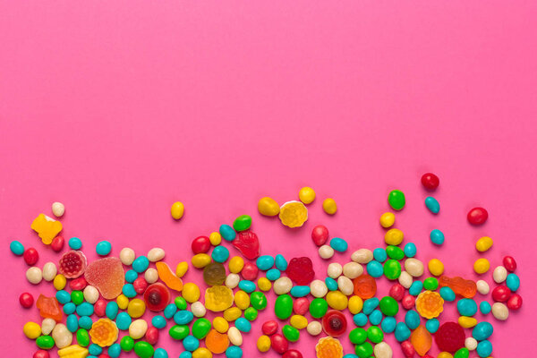 Colorful lollipops on a pink background