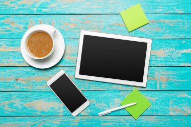 digital tablet and coffee cup on wooden table clipart