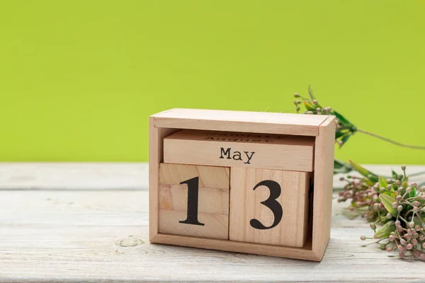 cube calendar for may 13th on wood with copy space