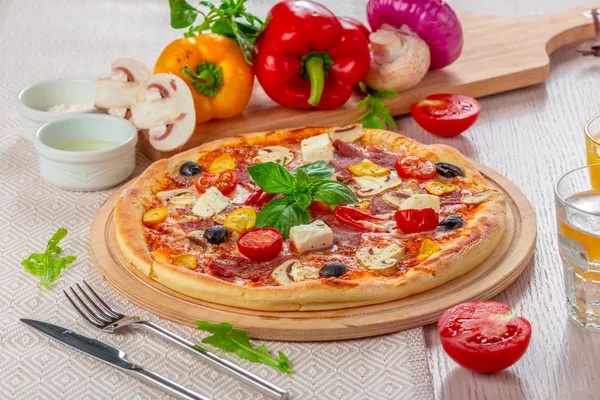 Pizza with Mozzarella, Ham, Cherry Tomatoes, Black Olives