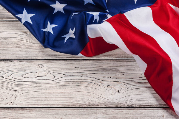 USA flag on light wooden table background close up copy space