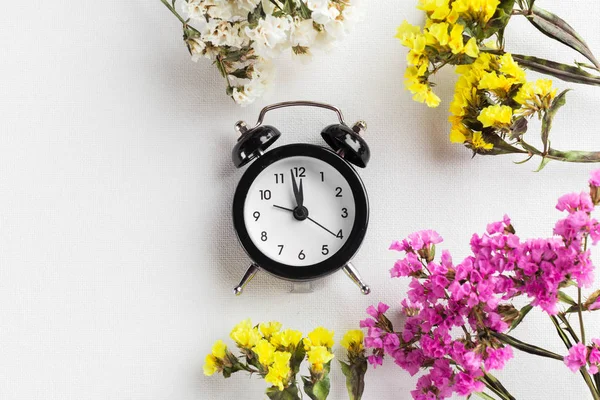 Spring Time Change Background with alarm clock and flower branches