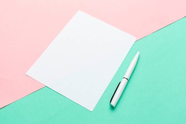 Pastel renk arkaplanı üzerine beyaz kağıt not defteri. Düz dizayn..