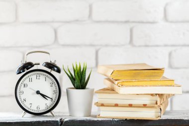 Nesneleri ile beyaz tuğla duvarda beyaz masada tencere ev bitkileri