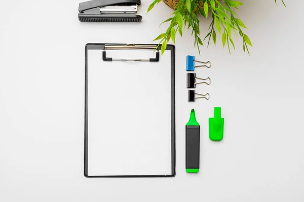 Home office workspace mockup with  green plant and stationery accessories with copy space background. Flat lay, top view
