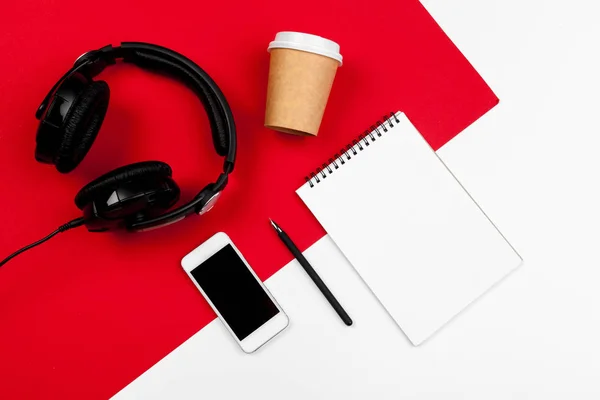 Headphones with cord on red and white color background