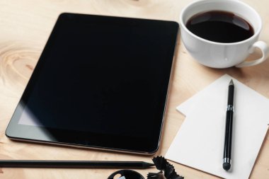 Dijital tablet bilgisayar ve bir fincan kahve..